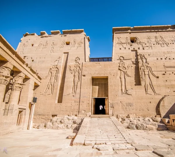 Monumental pylons covered with ancient Egyptian reliefs at the entrance to Philae Temple