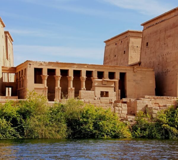 Philae Temple’s carved pylons and columned buildings viewed from the Nile in Aswan