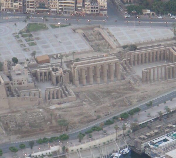 An aerial view of Luxor Temple’s pylons, colonnades and courtyards beside the Nile corniche
