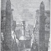 A monochrome historic illustration of two obelisks, columns and masonry at Luxor Temple